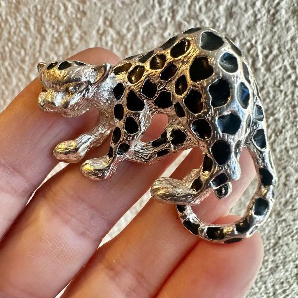 Silver tone and black jaguar brooch